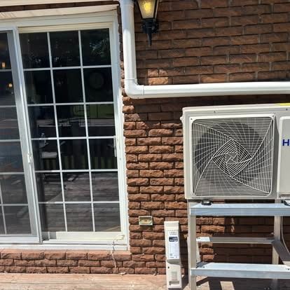 Heat pump on a white home